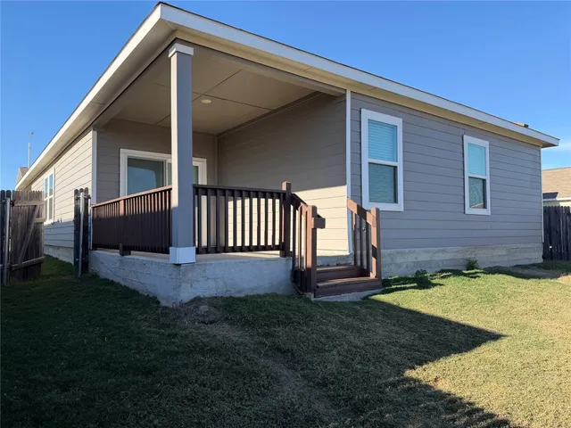 a view of backyard with porch and entertaining space