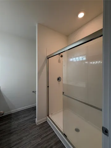 a bathroom with a glass shower door