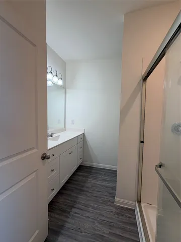a bathroom with a double vanity sink and mirror