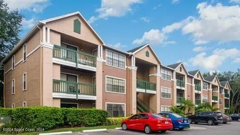 a front view of a residential apartment building with a yard