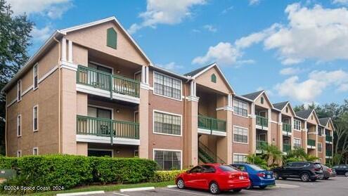 a front view of a residential apartment building with a yard