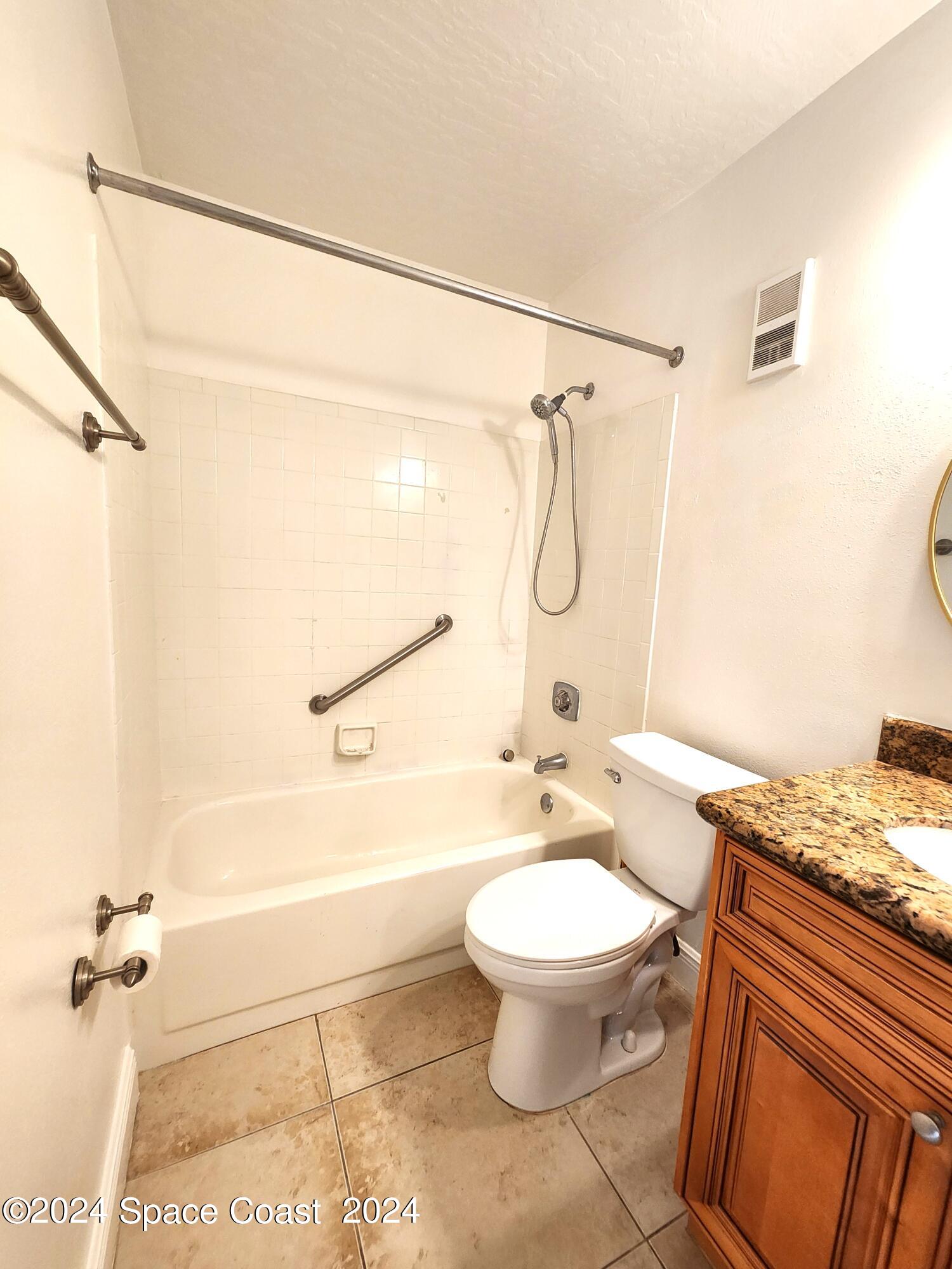 7667 North Wickham Road, Unit 601 Melbourne, FL 32940 - Photo 12 of 21 a bathroom with a granite countertop toilet sink and shower