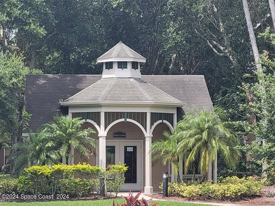 7667 North Wickham Road, Unit 601 Melbourne, FL 32940 - Photo 17 of 21 a front view of a house with yard