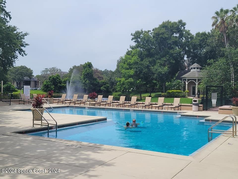 7667 North Wickham Road, Unit 601 Melbourne, FL 32940 - Photo 18 of 21 a view of swimming pool with outdoor seating and plants