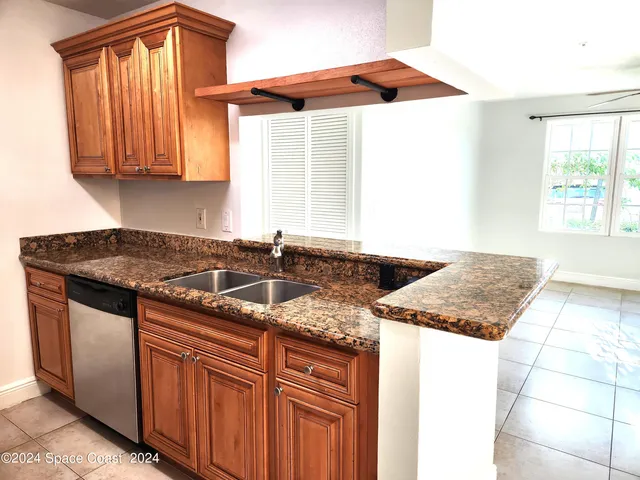 a kitchen with granite countertop a sink and a stove