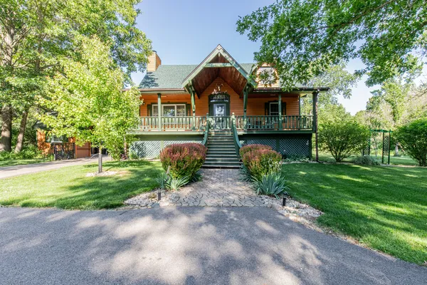 a front view of house with yard and green space