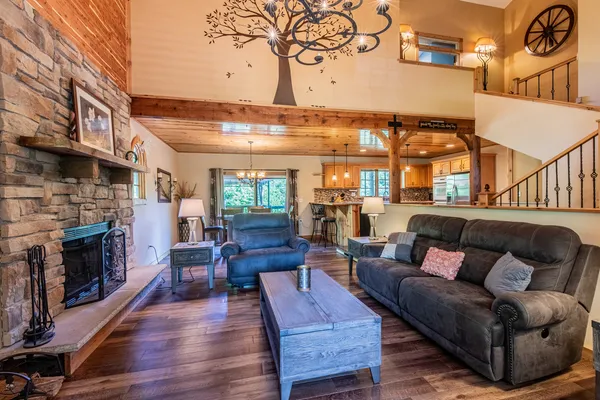 a living room with furniture a fireplace and a large mirror