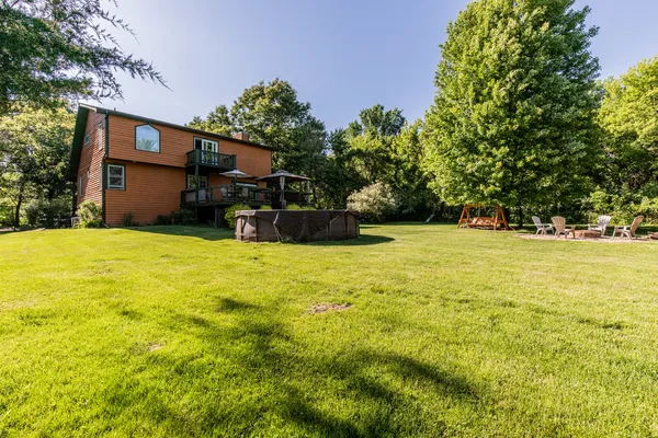 a view of chairs and table in the wooden deck