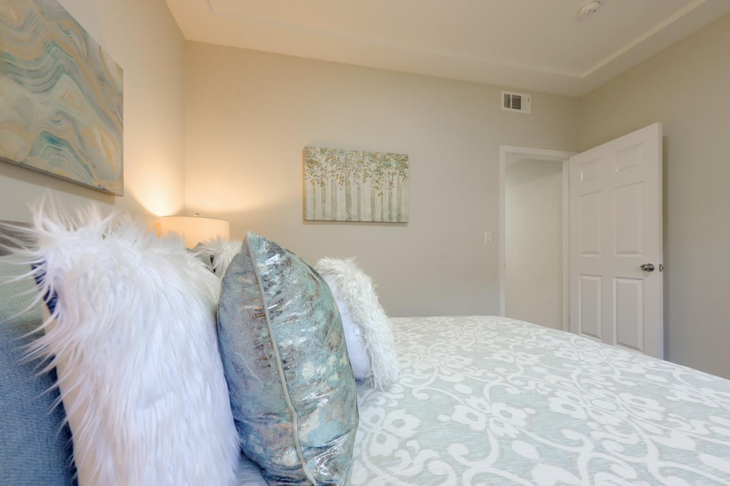 682 Willowgate Street Mountain View, CA 94043 - Photo 17 of 30 a view of a bedroom with wooden floor and a potted plant