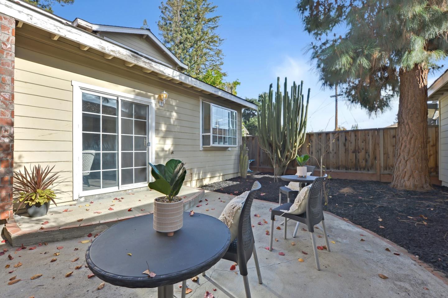 682 Willowgate Street Mountain View, CA 94043 - Photo 28 of 30 a view of a table and chairs in back yard of the house