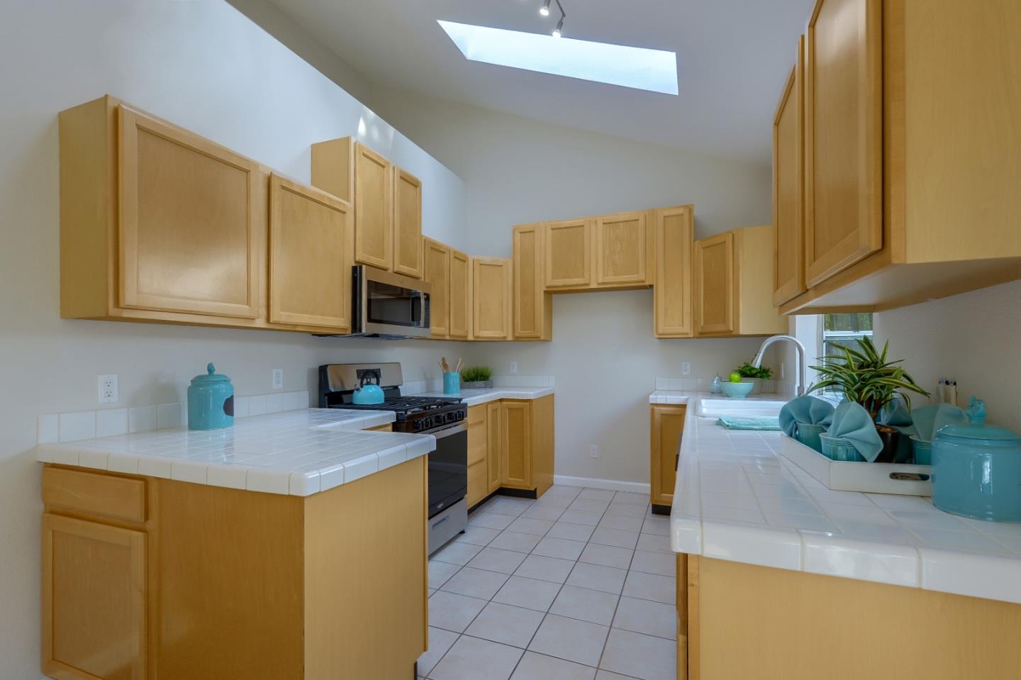 682 Willowgate Street Mountain View, CA 94043 - Photo 8 of 30 a kitchen with stainless steel appliances granite countertop a sink a stove top oven a counter space and cabinets