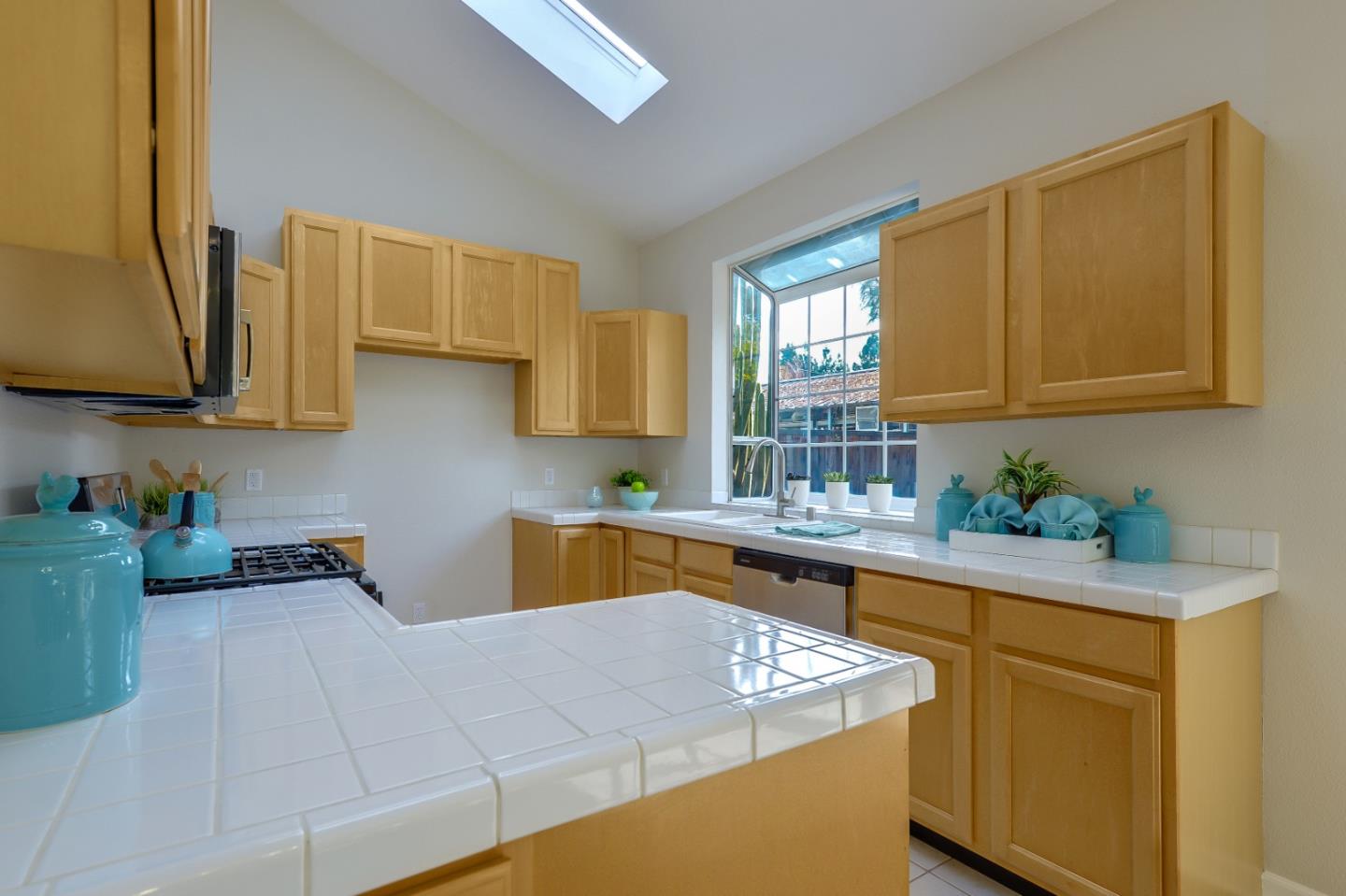 682 Willowgate Street Mountain View, CA 94043 - Photo 9 of 30 a kitchen with stainless steel appliances granite countertop a sink stove and cabinets