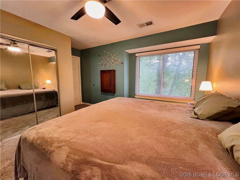 1505 Swiss Village Road, Unit A5 Osage Beach, MO 65065 - Photo 27 of 41 Large windows to take in nature and an access door