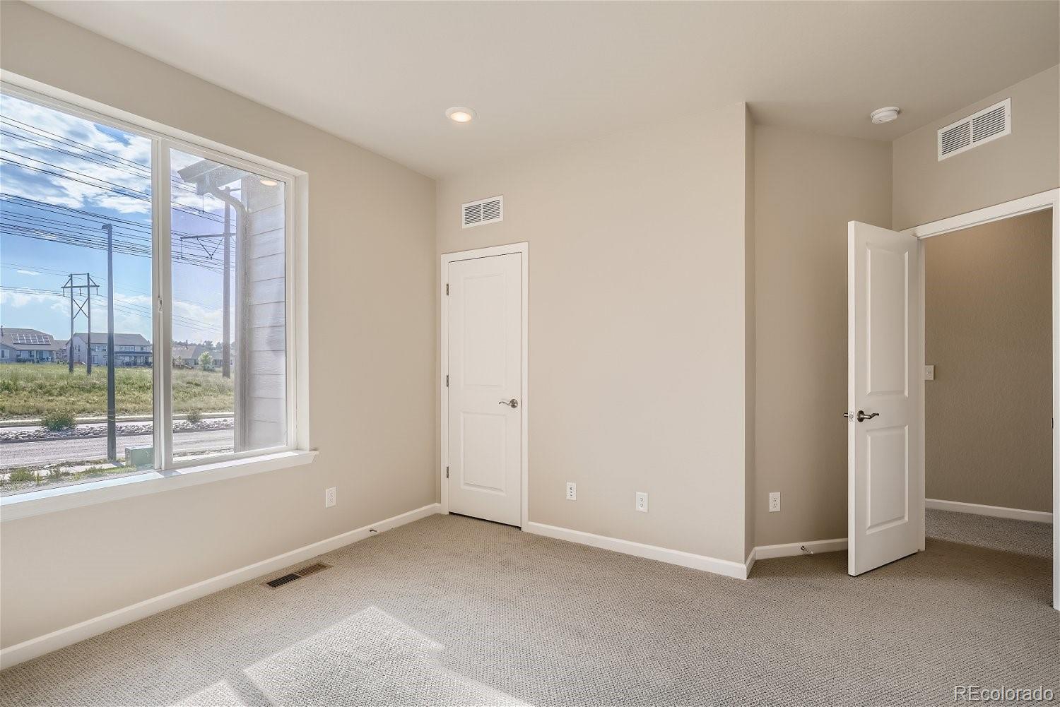 6700 Merseyside Lane Castle Pines, CO 80108 - Photo 13 of 28 a view of an empty room with a window