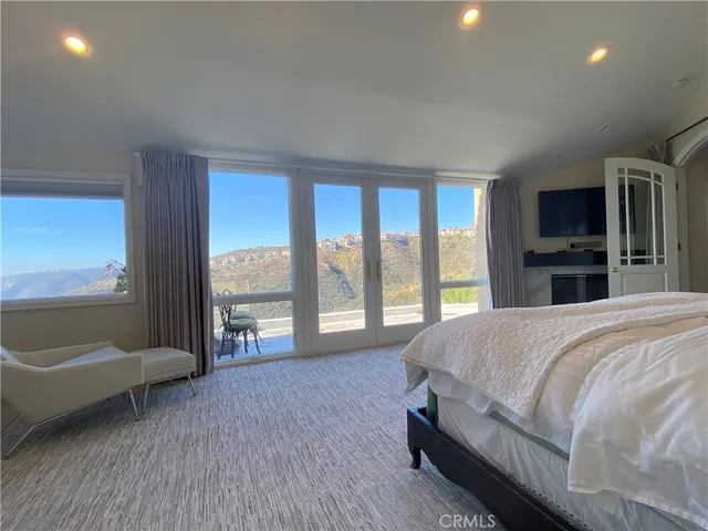 a spacious bedroom with a bed and a couch