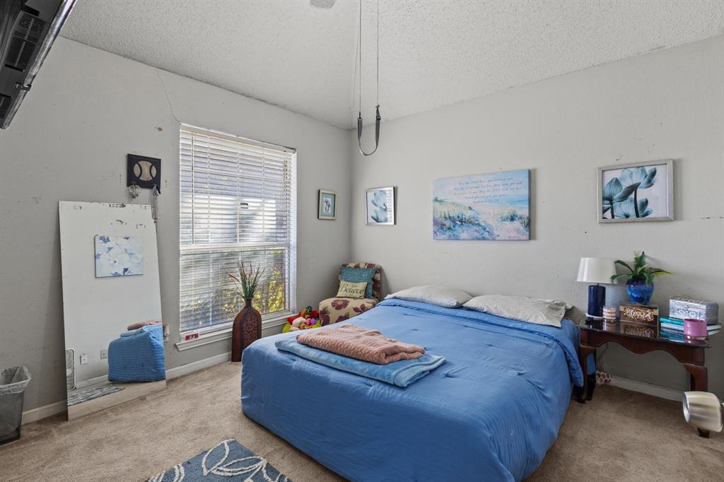 3717 Corn Valley Road Grand Prairie, TX 75052 - Photo 11 of 14 a bedroom with a bed a couch and a window