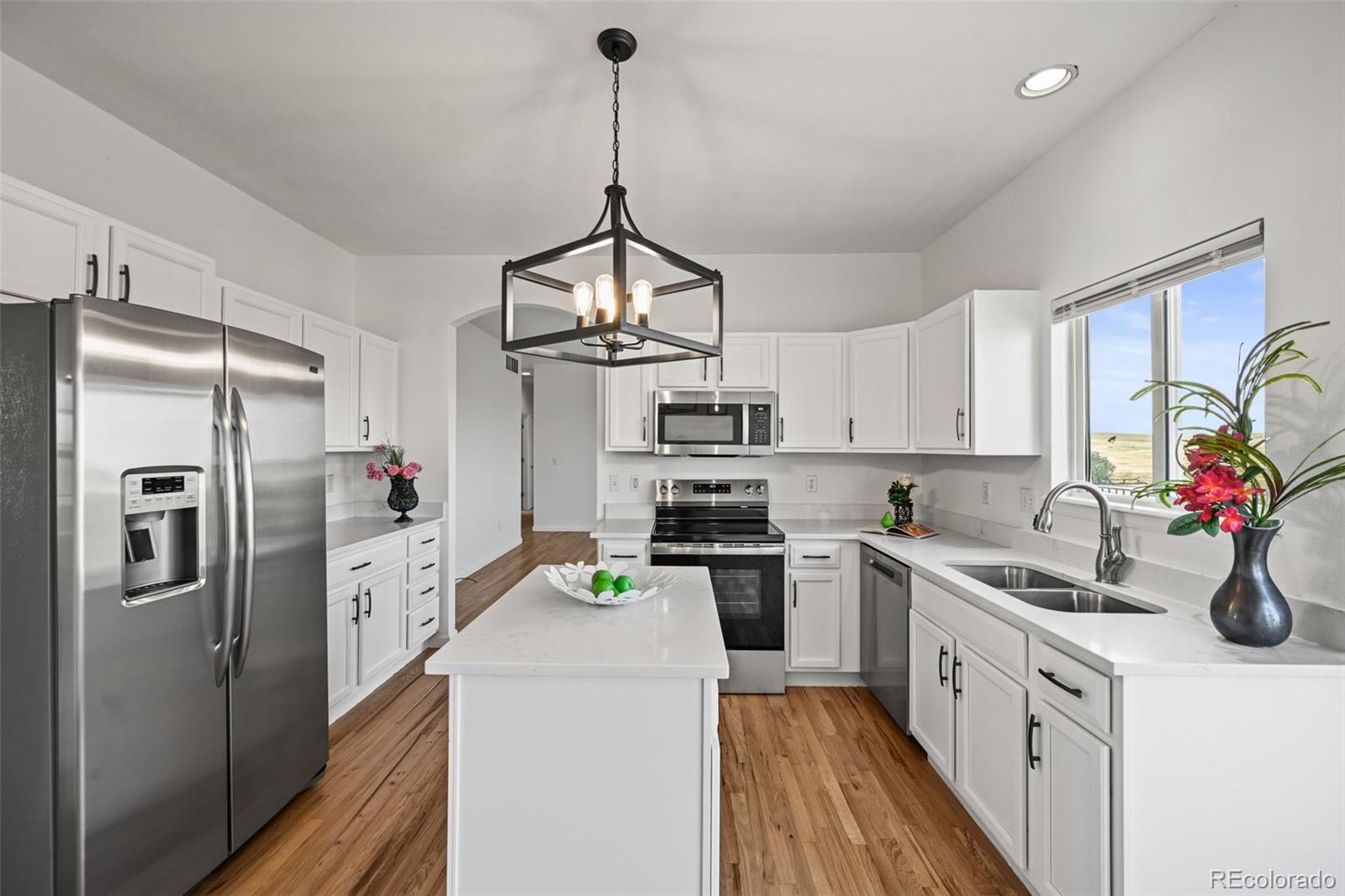 a kitchen with stainless steel appliances a sink stove and refrigerator