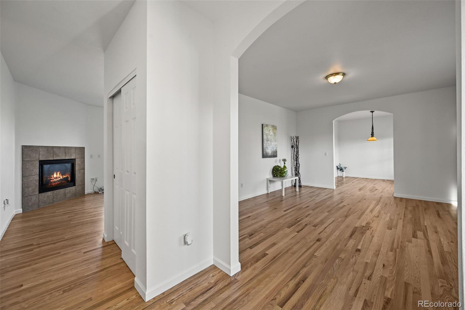 7498 Patrick Trail Elizabeth, CO 80107 - Photo 11 of 44 a view of a room with wooden floor and a fireplace
