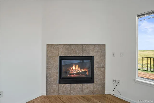 a living room with a fireplace and a fireplace