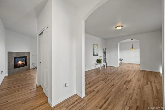 a view of a room with wooden floor and a fireplace