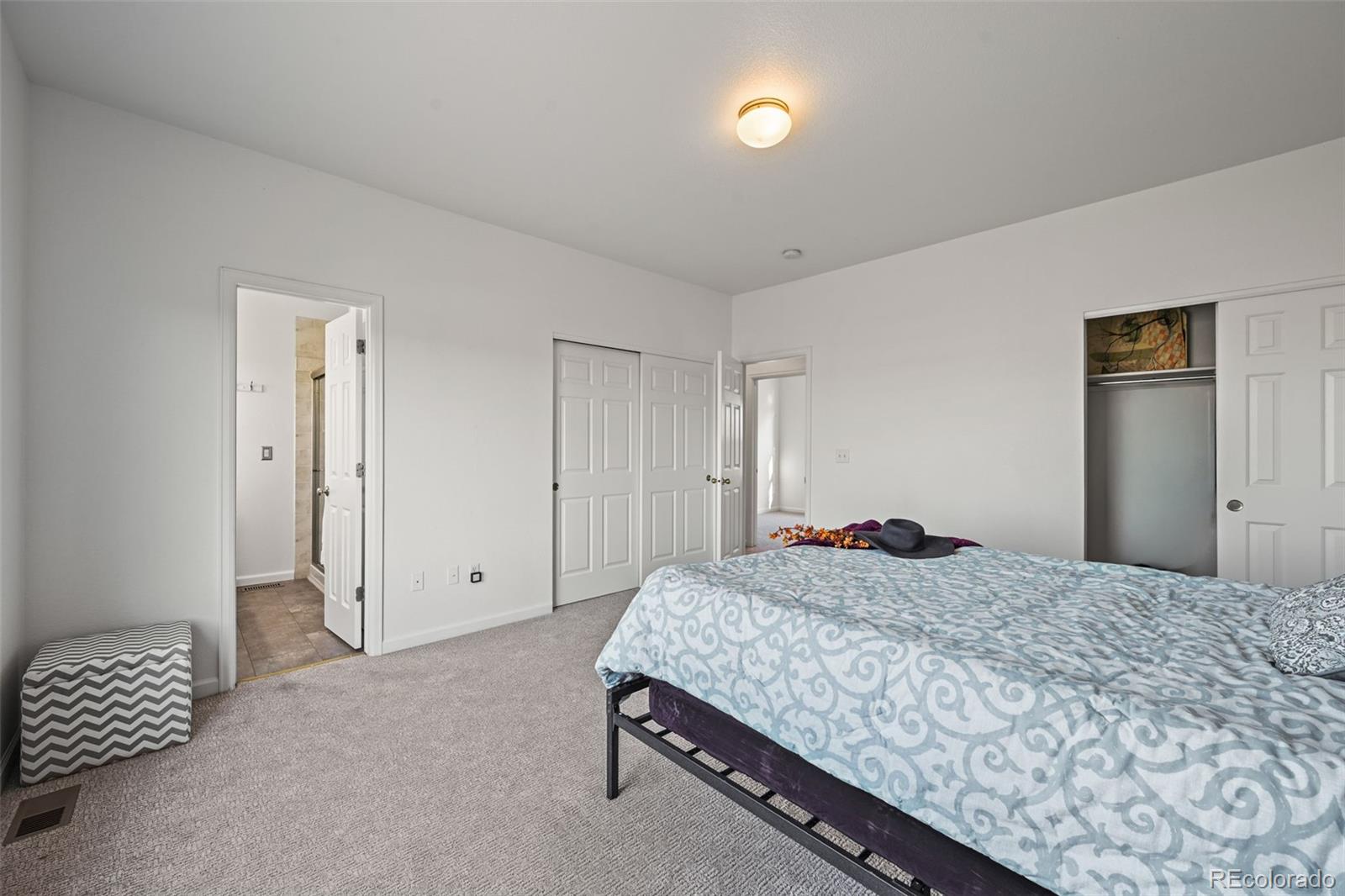 7498 Patrick Trail Elizabeth, CO 80107 - Photo 17 of 45 a bedroom with a bed and a chair