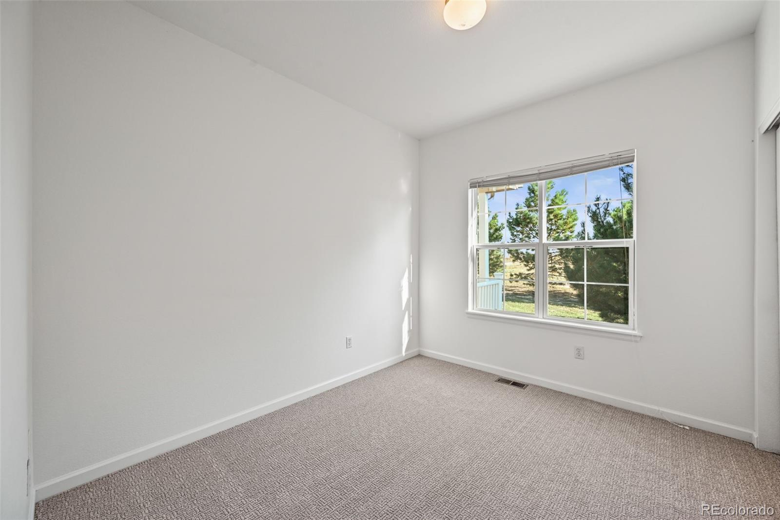 7498 Patrick Trail Elizabeth, CO 80107 - Photo 22 of 45 an empty room with a window