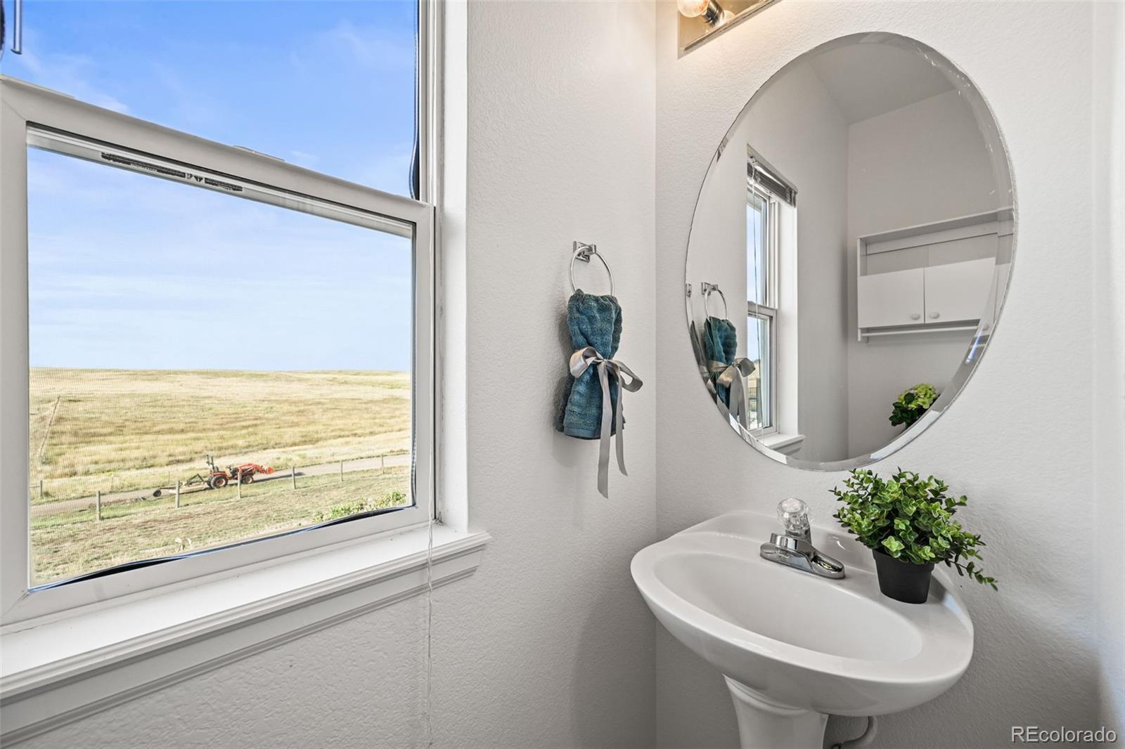7498 Patrick Trail Elizabeth, CO 80107 - Photo 27 of 45 a bathroom with a sink and mirror with bathtub