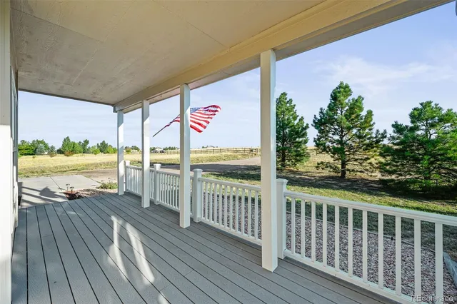 a view of a balcony with wooden floor