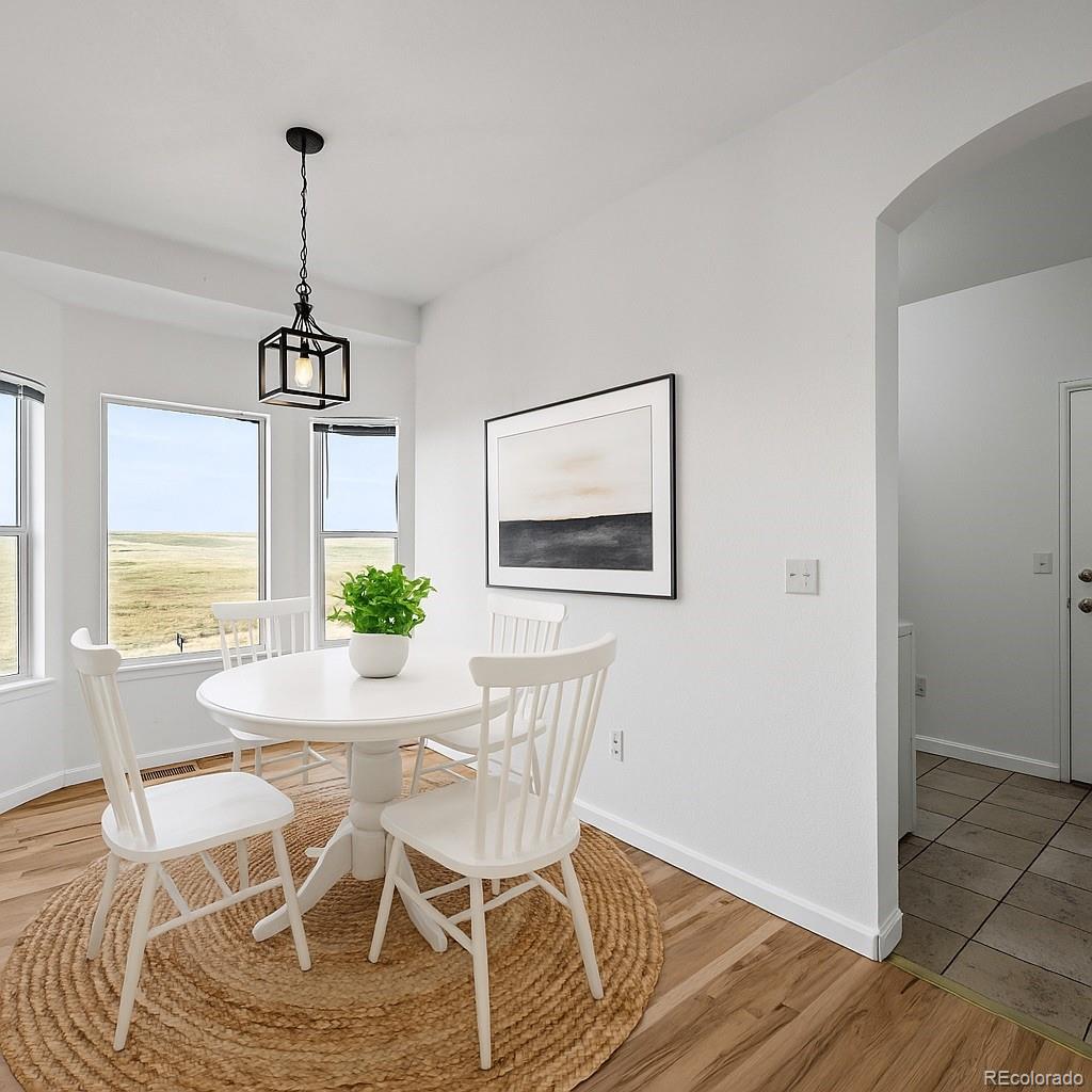 7498 Patrick Trail Elizabeth, CO 80107 - Photo 9 of 45 a view of a dining room with furniture window and wooden floor