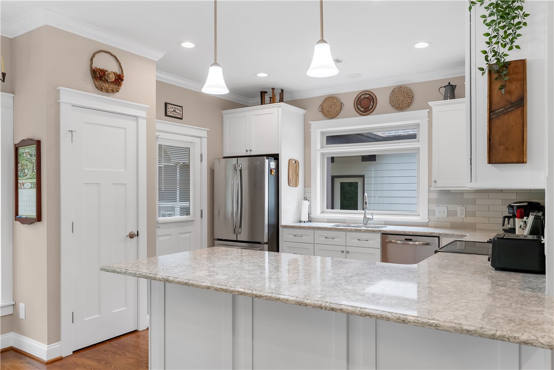 329 High Hampton Road Salem, SC 29676 - Photo 12 of 47 Gleaming stone countertops and classic crown molding accent this custom culinary workspace.
