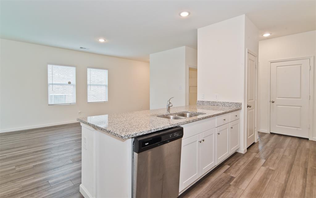 1637 Shadow Hawk Drive Fort Worth, TX 76052 - Photo 7 of 20 a kitchen with a sink stove and cabinets