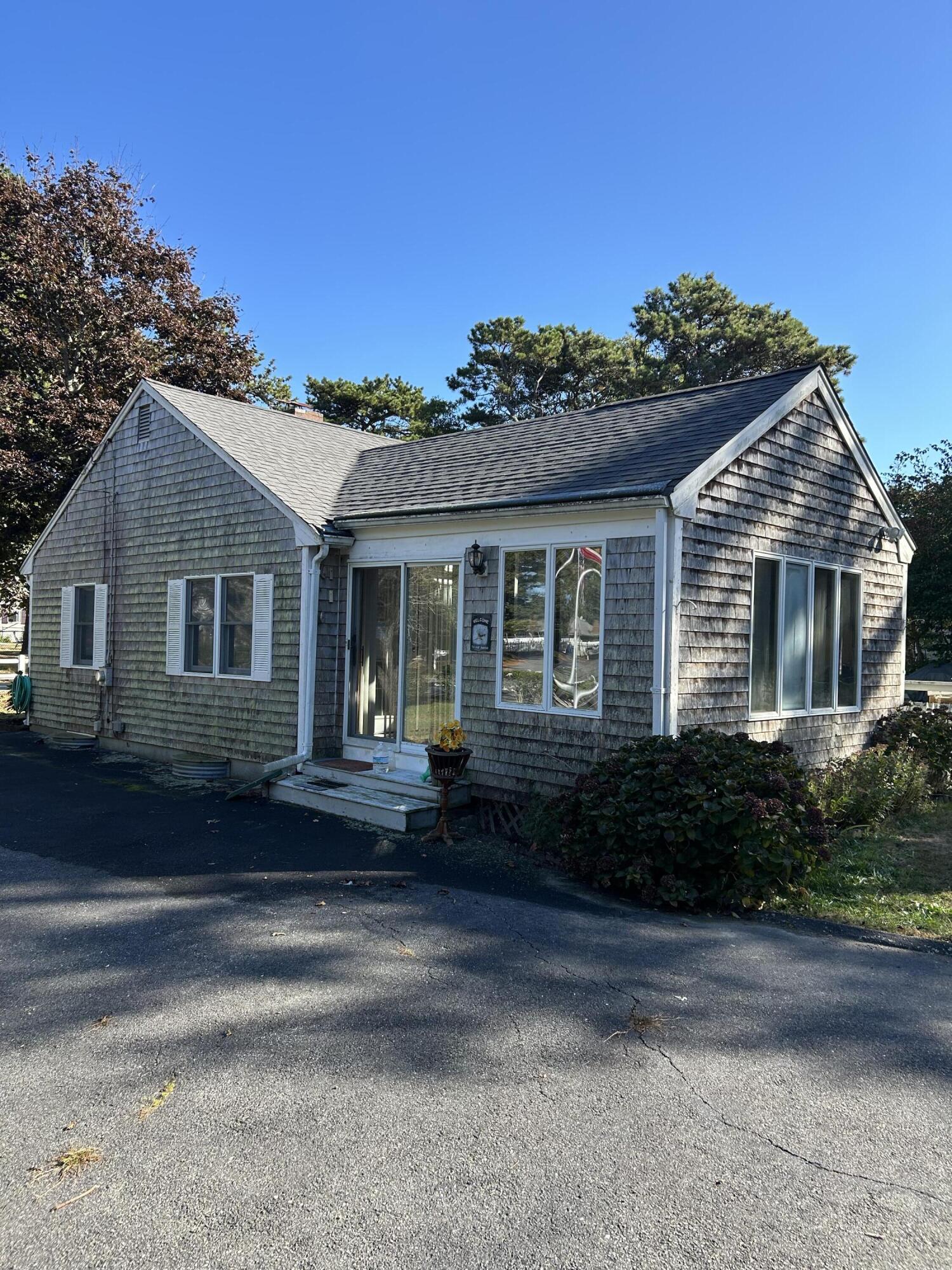 7 Delta Street Hyannis, MA 02601 - Photo 4 of 29 a front view of a house with a yard