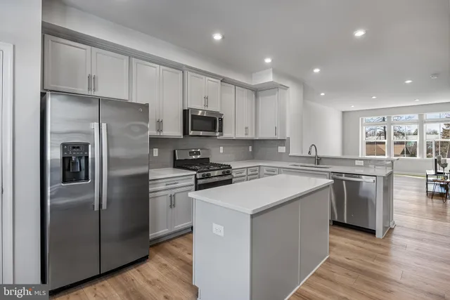 a kitchen with stainless steel appliances cabinets a sink and a counter top space