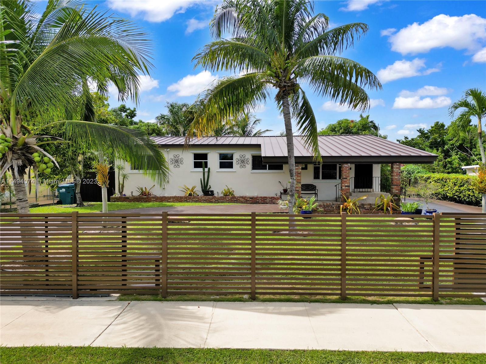 3300 Southwest 80th Avenue Miami, FL 33155 - Photo 1 of 31 a front view of a house with a yard