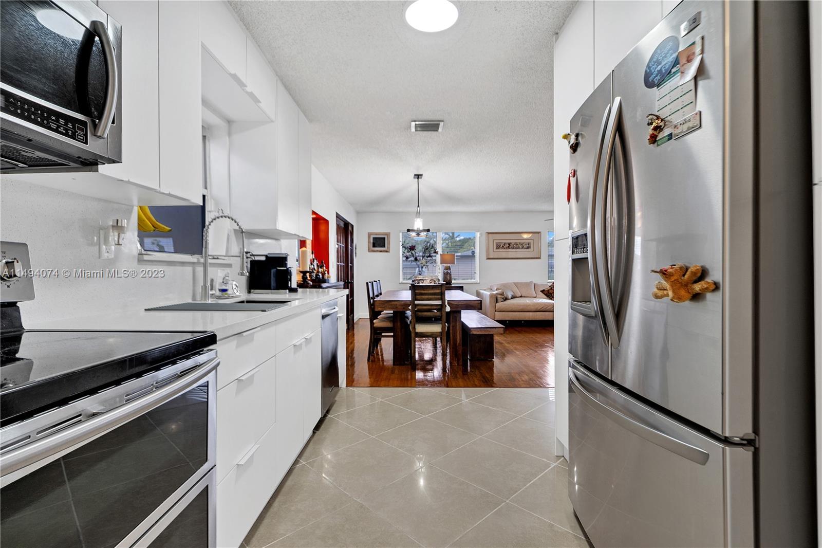 3300 Southwest 80th Avenue Miami, FL 33155 - Photo 16 of 31 a kitchen with refrigerator and cabinets