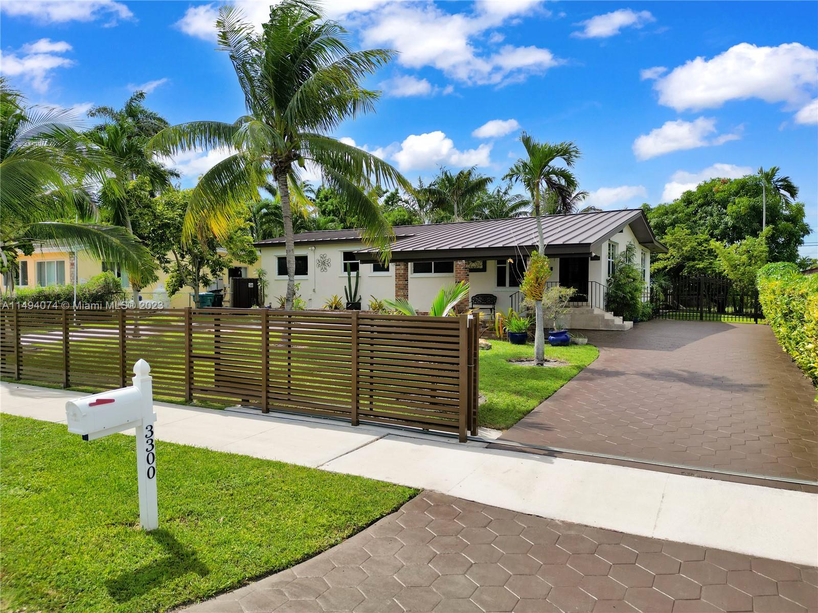 3300 Southwest 80th Avenue Miami, FL 33155 - Photo 2 of 31 a house view with a garden space
