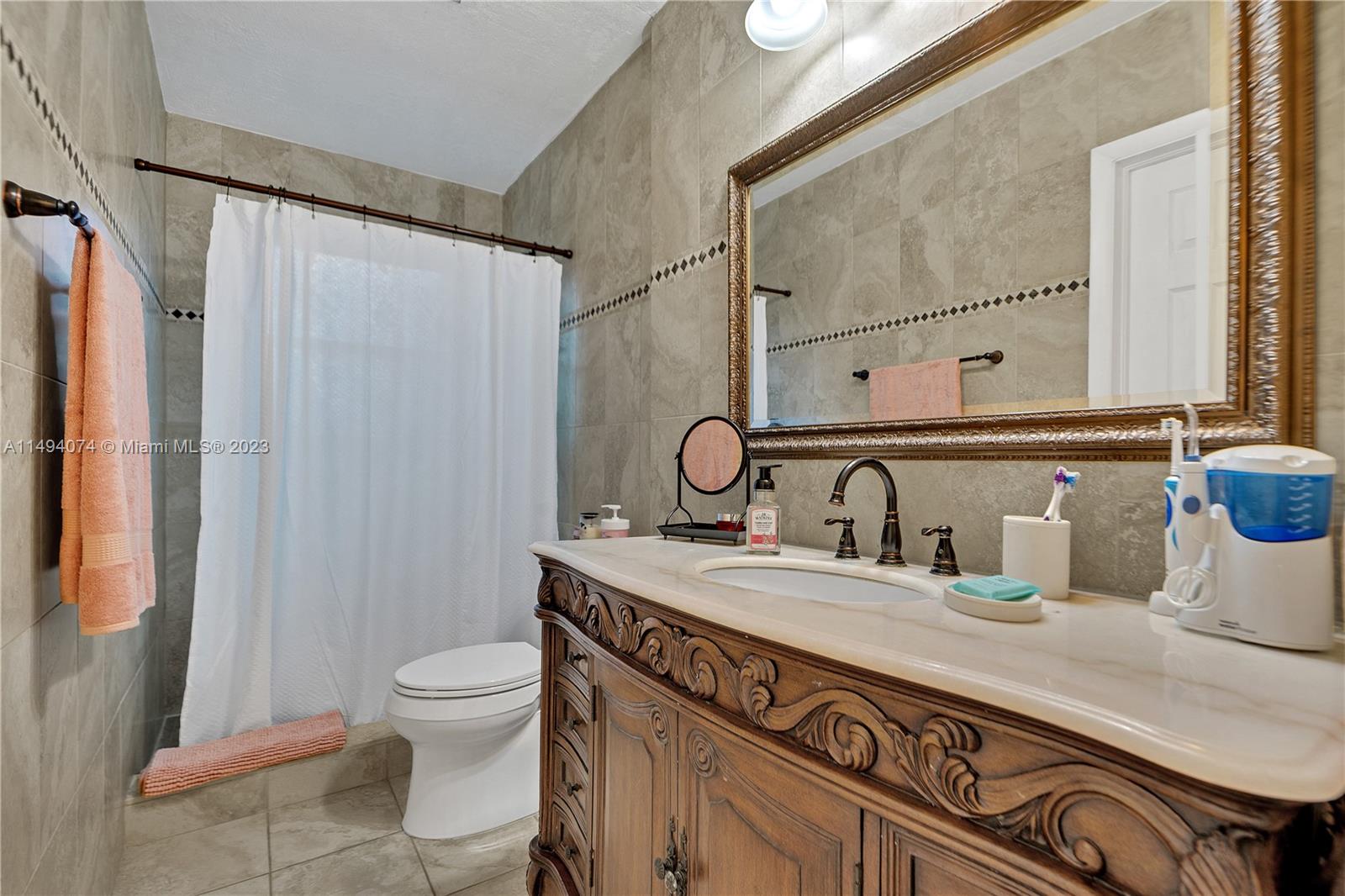 3300 Southwest 80th Avenue Miami, FL 33155 - Photo 21 of 31 a bathroom with a granite countertop sink a toilet and a mirror
