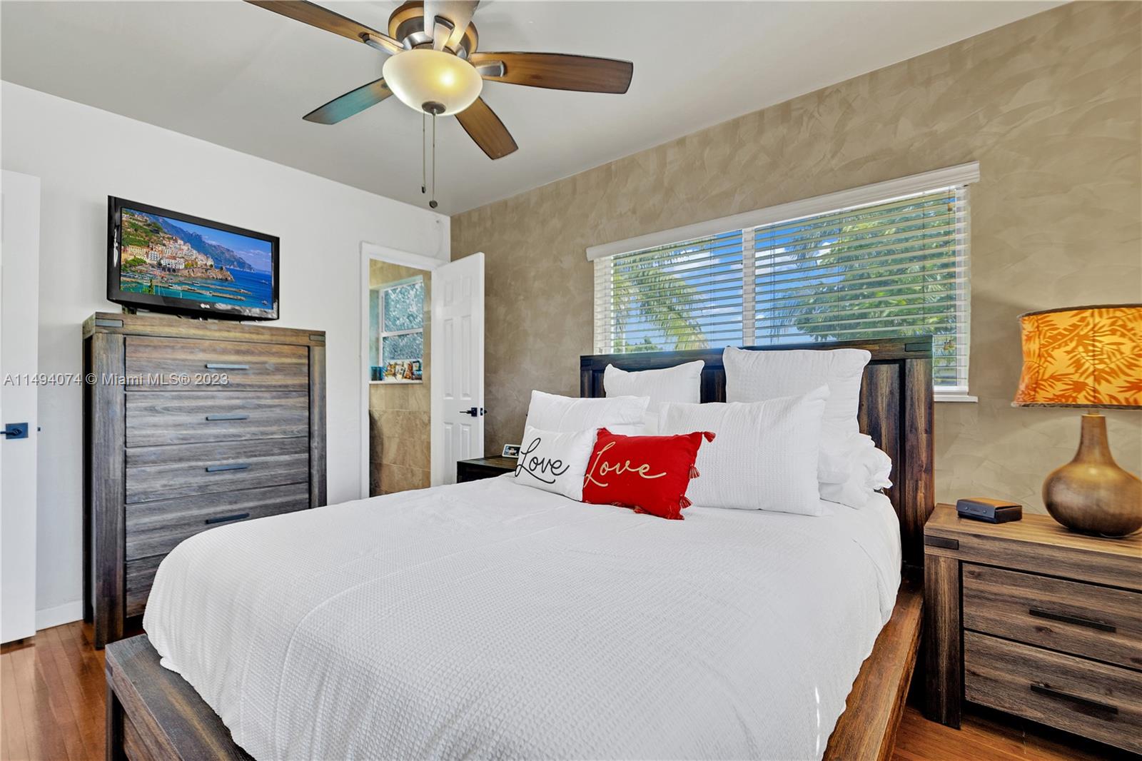 3300 Southwest 80th Avenue Miami, FL 33155 - Photo 23 of 31 a bedroom with a bed and a chandelier