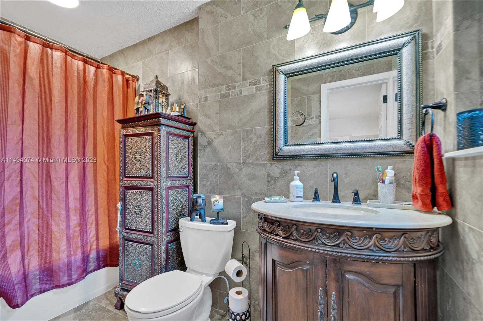 3300 Southwest 80th Avenue Miami, FL 33155 - Photo 24 of 31 a bathroom with a toilet a sink and a mirror