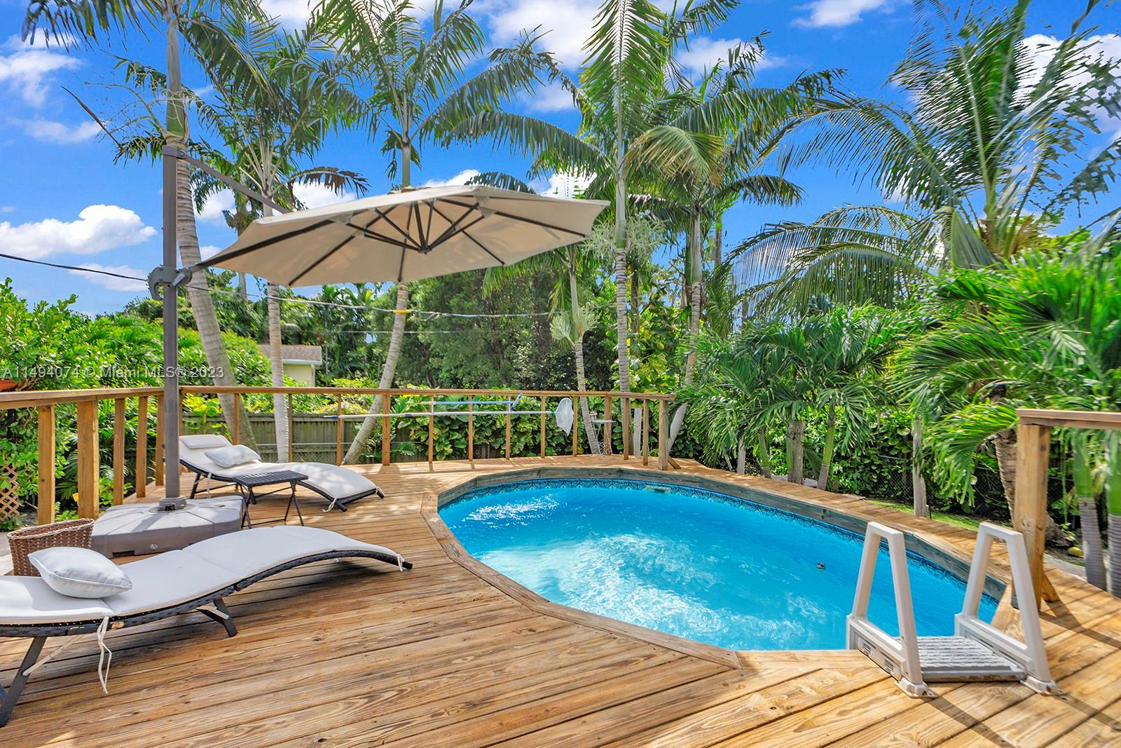 3300 Southwest 80th Avenue Miami, FL 33155 - Photo 31 of 31 a view of a swimming pool with a lounge chairs