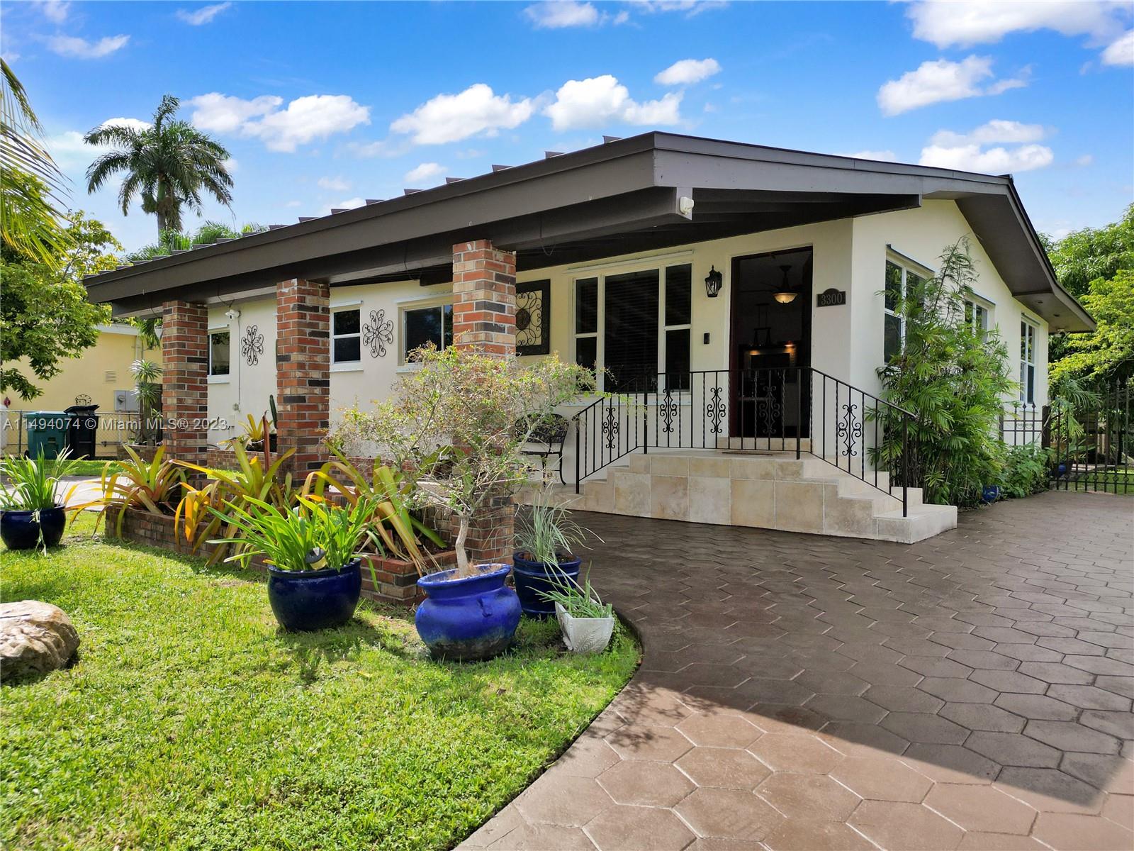 3300 Southwest 80th Avenue Miami, FL 33155 - Photo 9 of 31 a front view of house with yard and seating space