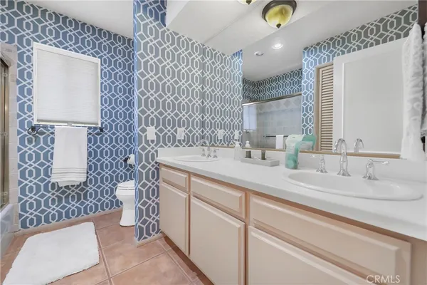 a bathroom with a sink mirror and vanity