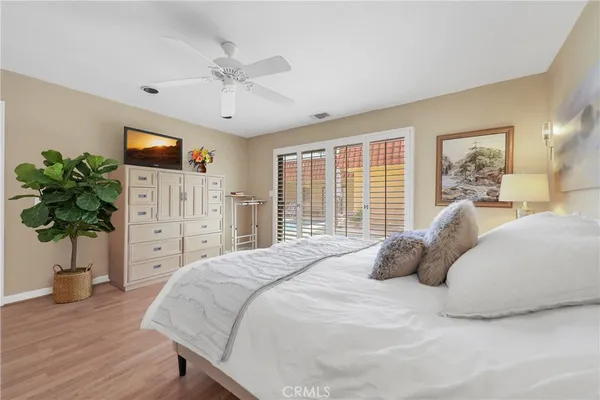 a bedroom with a bed and a potted plant