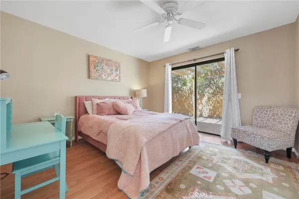 a spacious bedroom with a bed and a couch