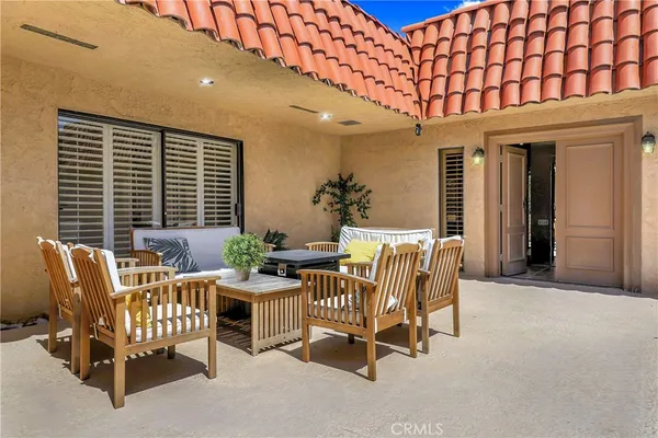 a view of a patio with a table and chairs