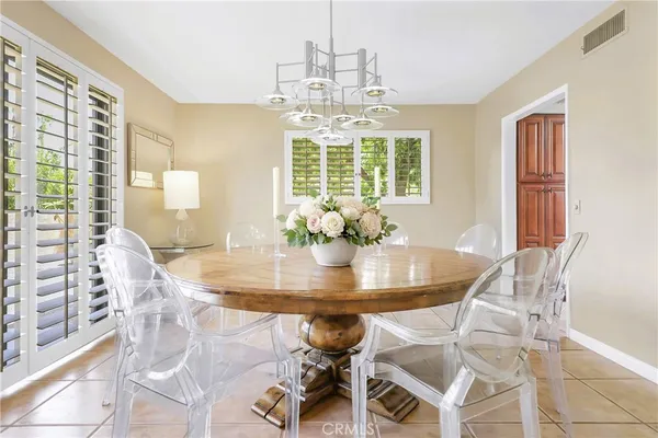 a view of a dining room with furniture wooden floor and chandelier