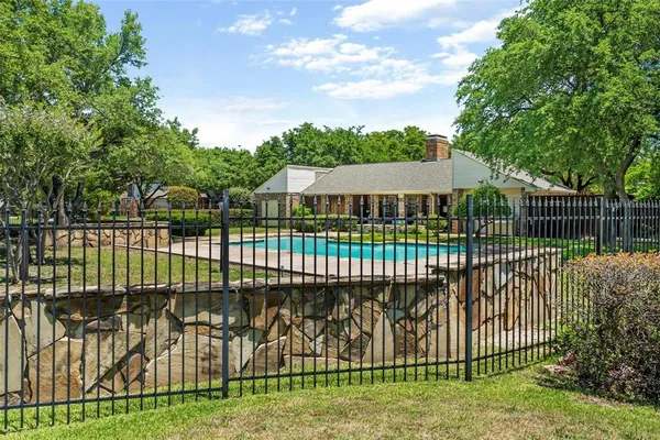 a view of a wrought iron fences in front of house