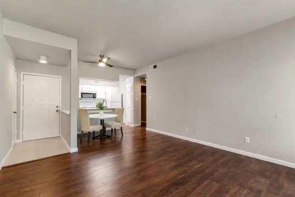 a view of a kitchen with wooden floor and a kitchen