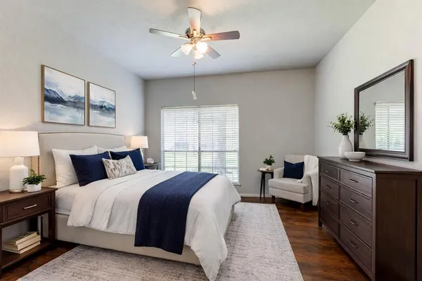 a spacious bedroom with a bed and a chandelier