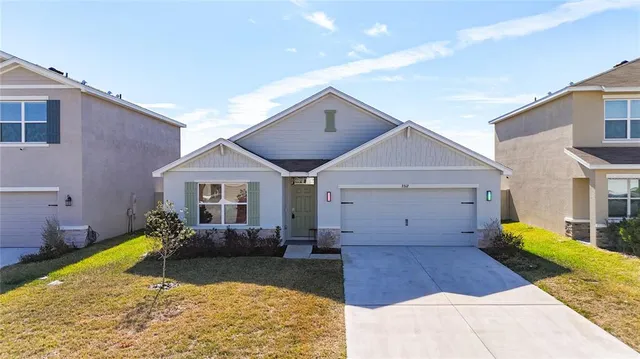 a view of a hallway with wooden floor and a bathroom